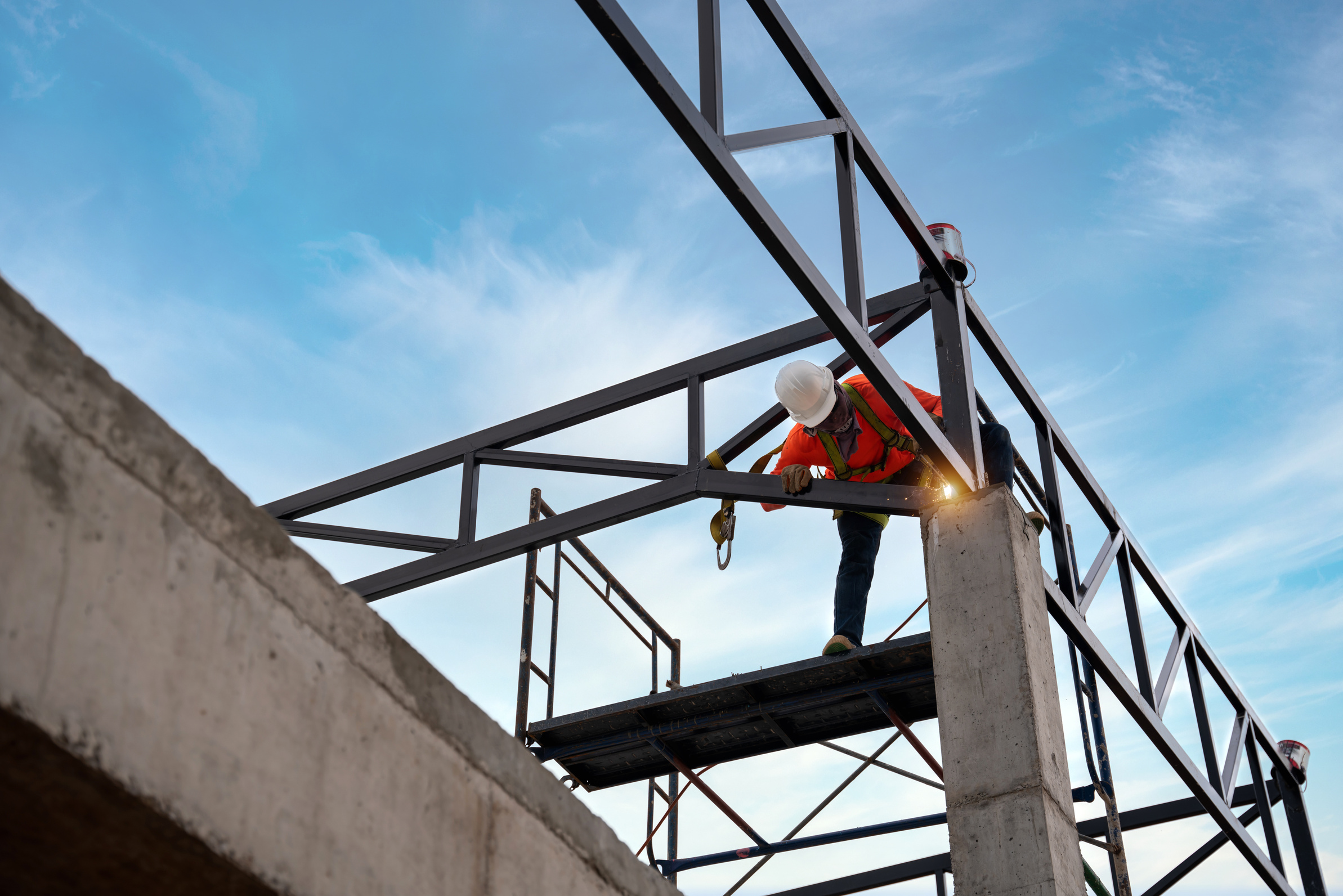 A Welders on risk areas. Steel roof truss welders are working on
